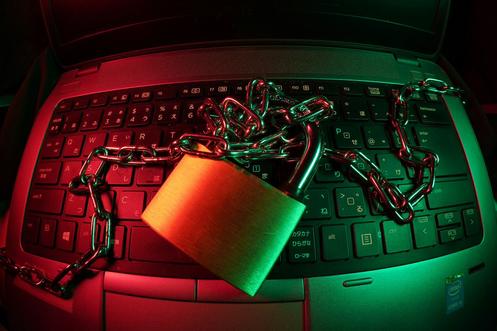 brown padlock on black computer keyboard symbolizing cyber liability insurance